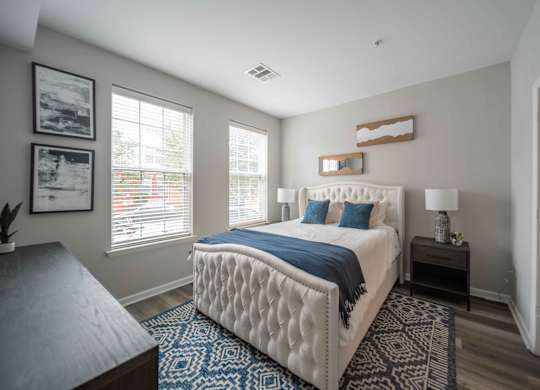 a bedroom with a large bed and two windows  at Harbor Pointe, Bayonne, NJ, 07002