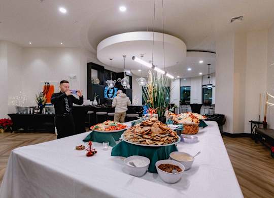 A buffet table with a variety of foods including pizza, salad, and dips at Metro 303, Hempstead, NY, 11550