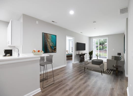 an open living room and kitchen with a table and chairs and a couch at The Lena, Raritan, NJ 08869