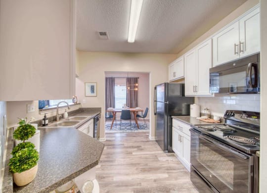 a kitchen with white cabinets at Meridian Obici, Virginia, 23434