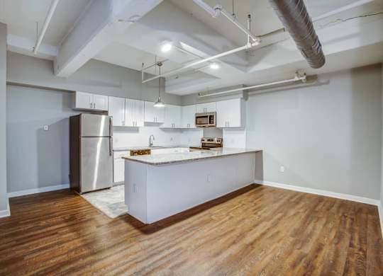 A kitchen with a refrigerator and a countertop.