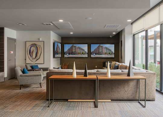 A modern office space with a large desk and a couch at Regatta Sloans Lake Apartments, Denver
