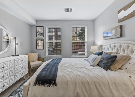 a bedroom with a large bed and two windows  at Harbor Pointe, New Jersey, 07002
