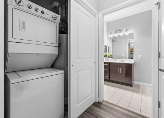 a washer and dryer in a kitchen with a bathroom in the background  at Harbor Pointe, Bayonne, New Jersey