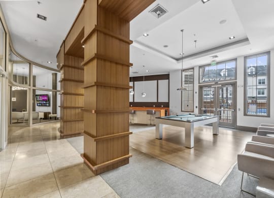 Hallway to Gym, Business Center, Game Room, and The Clubhouse with a pool table, entrance to outdoor pool, a bar and kitchen at Harbor Pointe, New Jersey, 07002