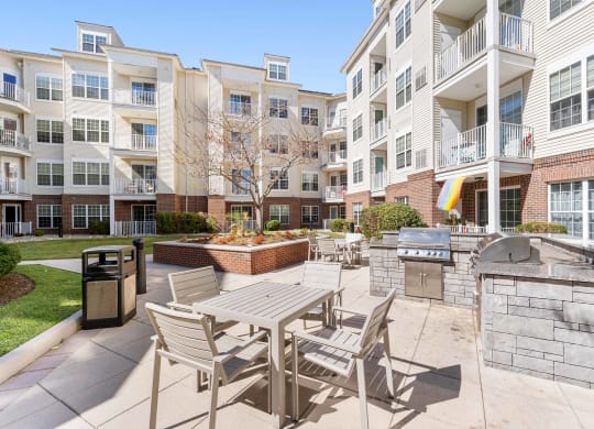 Courtyard with a grill and tables and chairs at The Lena, Raritan, NJ 08869