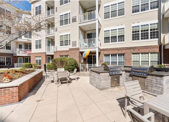 Courtyard with a grill and tables and chairs at The Lena, Raritan, 08869