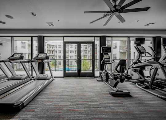 A gym with treadmills and elliptical machines at Regatta Sloans Lake Apartments, Denver, CO