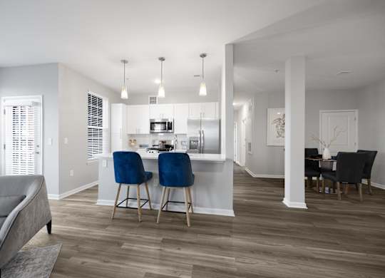 A modern kitchen with a dining table and chairs.
