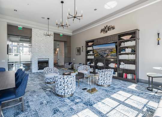 A large room with a fireplace and a blue carpet.