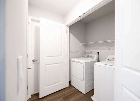 A white laundry room with a washer and dryer.