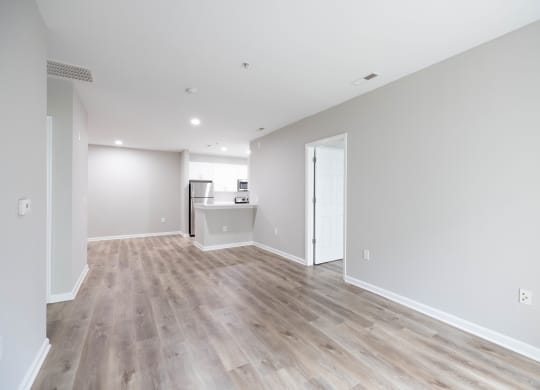 a living room with a hard wood floor and white walls at The Lena, Raritan, NJ 08869