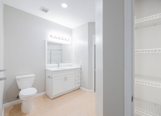 a white bathroom with a toilet and a sink at The Lena, Raritan, NJ 08869