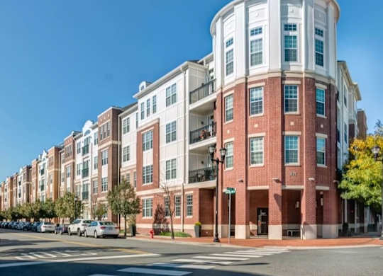 A red brick building with a white section on the top floor.