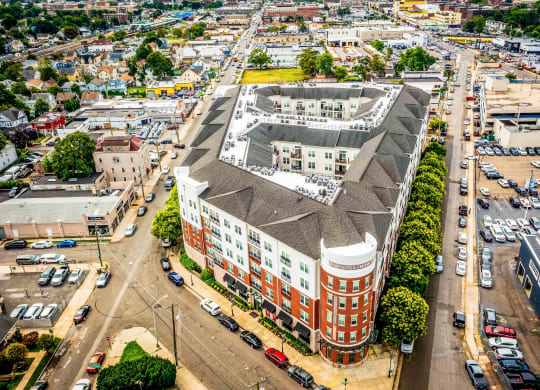an aerial view of a large brick building with a gray roof at Metro 303, Hempstead