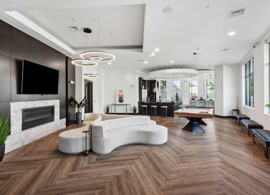 Modern living room with a fireplace and a white sofa at Metro 303, Hempstead, NY