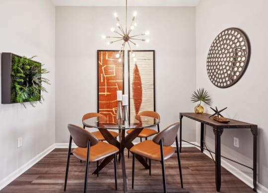 a dining room with a table and chairs at Metro 303, Hempstead, 11550