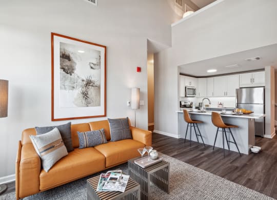 a living room with a couch coffee table and a kitchen in the background at Metro 303, New York