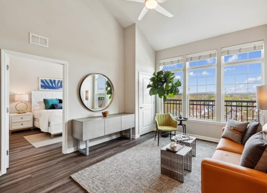 Living room with couch, table and balcony view at Metro 303, Hempstead, 11550