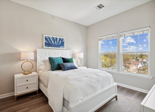 a bedroom with a bed and two windows at Metro 303, New York