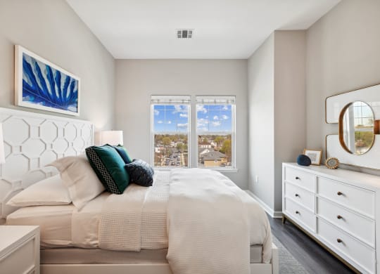 a bedroom with a large bed and a large window at Metro 303, Hempstead, NY 11550