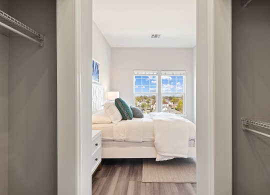a bedroom with a bed and a window at Metro 303, Hempstead, 11550