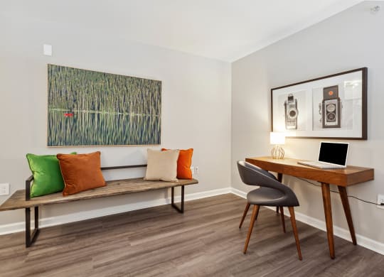 a room with a desk and chair and a painting on the wall at Metro 303, Hempstead New York