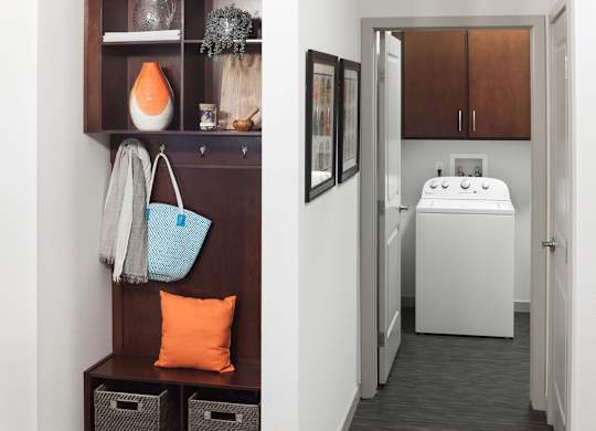 A bathroom with a white sink and a brown cabinet at Regatta Sloans Lake Apartments, Denver, CO