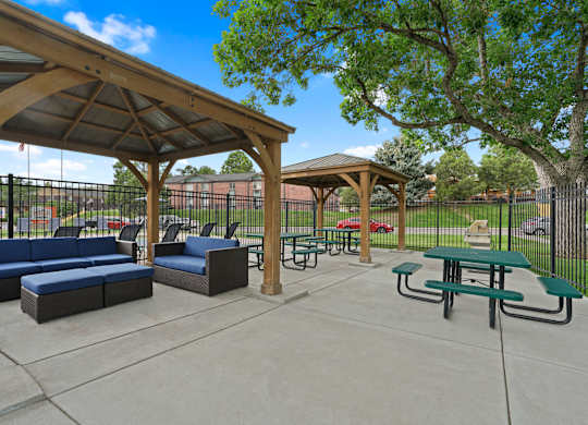 A park with a pavement, a gazebo, a bench and a table at Mountain Vista Apartments, Lakewood, 80228