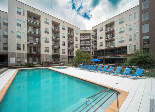 A large swimming pool in front of apartment buildings at Regatta Sloans Lake Apartments, Denver 80204
