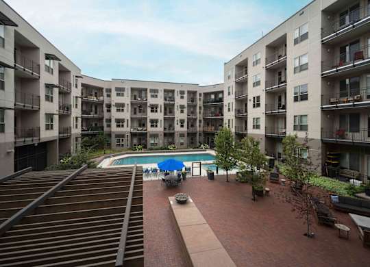 Apartment complex with a pool in the middle at Regatta Sloans Lake Apartments, Denver, CO