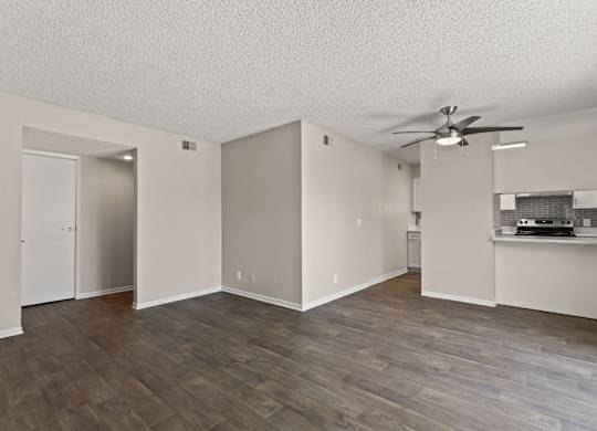 A room with a ceiling fan and wooden flooring at The Ranch at Bear Creek Apartments, Lakewood, CO, 80227