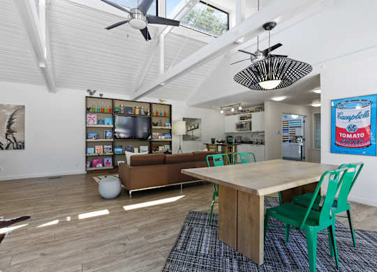 A room with a table, chairs and a ceiling fan at The Ranch at Bear Creek Apartments, Colorado