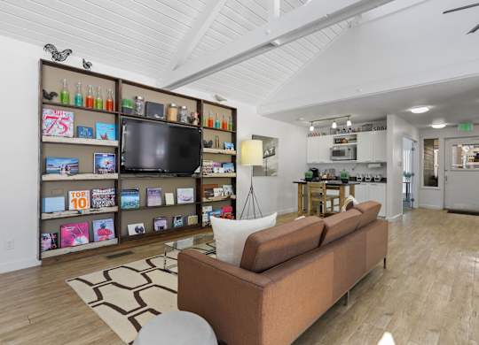 A living room with a couch and a television at The Ranch at Bear Creek Apartments, Lakewood