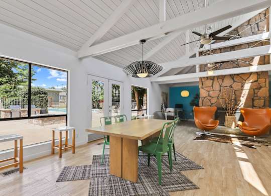 A room with a table and chairs and a ceiling fan at The Ranch at Bear Creek Apartments, Lakewood, CO