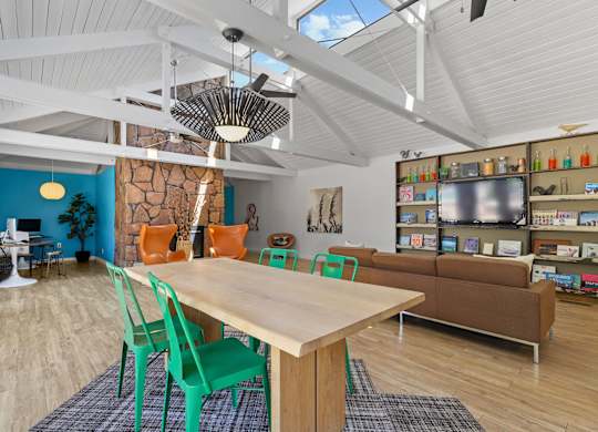 A room with a table and chairs in the foreground and a shelving unit in the background at The Ranch at Bear Creek Apartments, Lakewood, CO, 80227