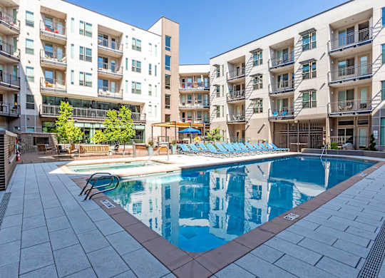 A large swimming pool in front of apartment buildings at Regatta Sloans Lake Apartments, Denver, 80204