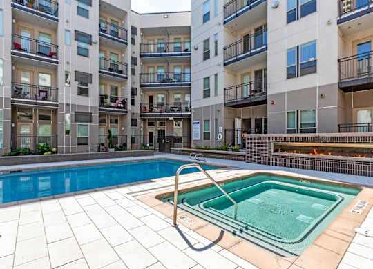 A swimming pool in a courtyard surrounded by apartment buildings at Regatta Sloans Lake Apartments, Colorado, 80204