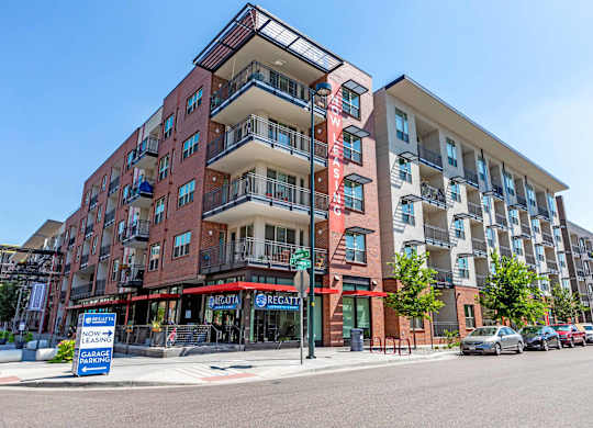 A multi-story apartment building with a red and white sign  at Regatta Sloans Lake Apartments, Denver, Colorado