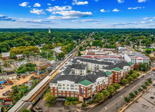 an aerial view of a large city with green trees and a blue sky at West 130, West Hempstead, NY 11552