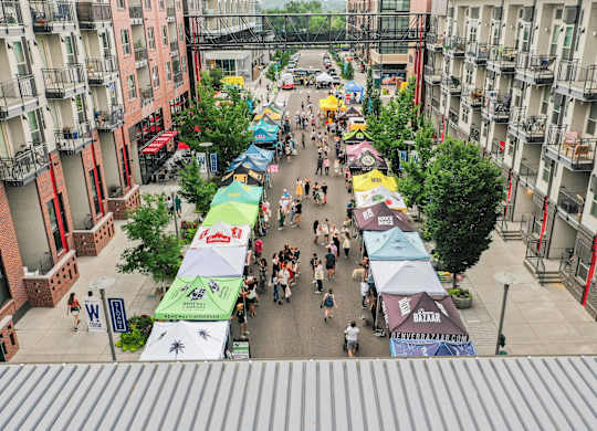 A street market with many people walking around at Regatta Sloans Lake Apartments, Denver, 80204