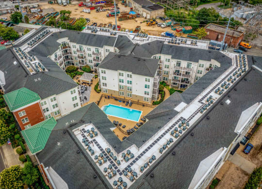 an aerial view of a large apartment complex with a swimming pool at West 130, West Hempstead New York