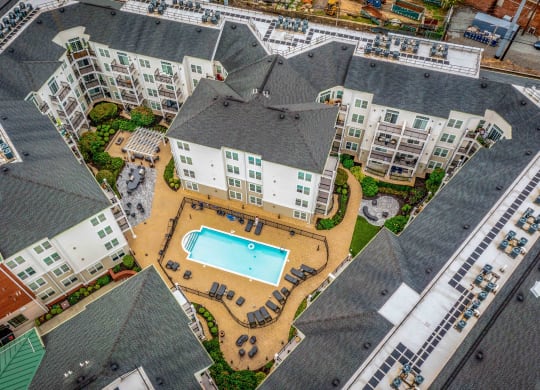 an aerial view of the resort style pool and hot tub at the reserve at south coast apartments at West 130, West Hempstead, 11552
