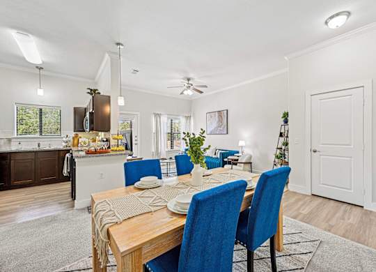 Dinning table with blue chairs at The Laurel at Vintage Park 55+ Apartments, Tomball, TX, 77377