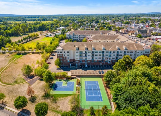 an aerial view of the beautiful property showcasing a half basketball and full tennis court at The Lena, Raritan, New Jersey