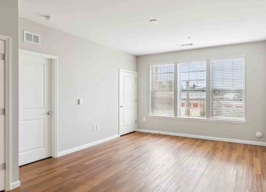 a bedroom with hardwood floors and a large window at West 130, New York , 11552