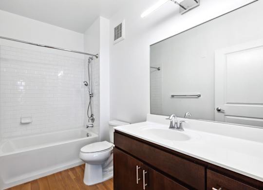 Large Soaking Tub In Master Bathroom With white Tile Surround at West 130, West Hempstead, New York 