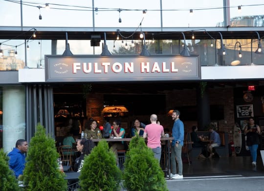 people standing outside of a restaurant with a sign at The Paxton, Brooklyn, NY