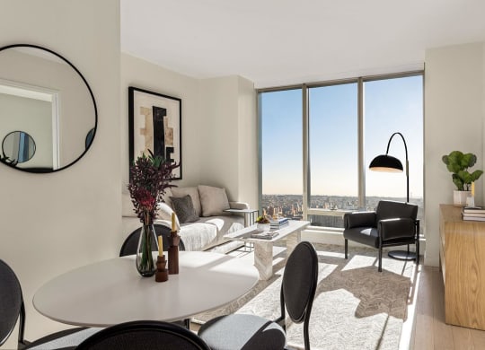 a living room with a view and a table and chairs at The Paxton, Brooklyn, NY