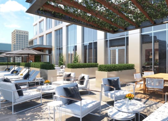 a rendering of a terrace with tables and chairs on the roof of a building at The Paxton, Brooklyn, 11201